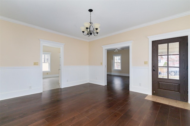 32 Reservoir Dr, Millbrook, NY 12545 - foyer featuring a chandelier, a wainscoted wall, wood finished floors, and crown molding