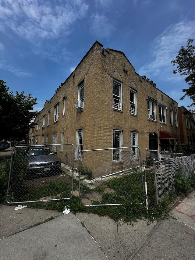 1661 E 172nd St, Bronx, NY 10472 - view of building exterior with a fenced front yard and cooling unit