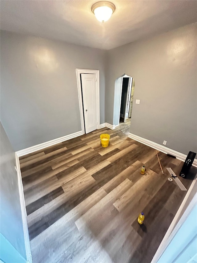 1661 E 172nd St, Bronx, NY 10472 - spare room featuring arched walkways and wood finished floors