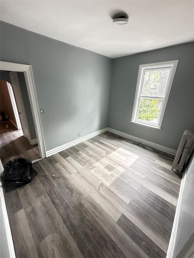 1661 E 172nd St, Bronx, NY 10472 - unfurnished bedroom featuring wood finished floors and baseboards