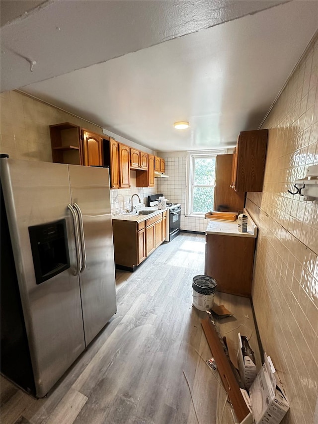1661 E 172nd St, Bronx, NY 10472 - kitchen with stainless steel refrigerator with ice dispenser, range with gas stovetop, light wood-style floors, light countertops, and open shelves