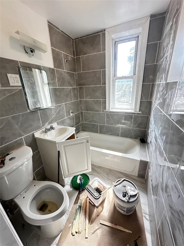 1661 E 172nd St, Bronx, NY 10472 - bathroom featuring tile walls, a tub, and vanity