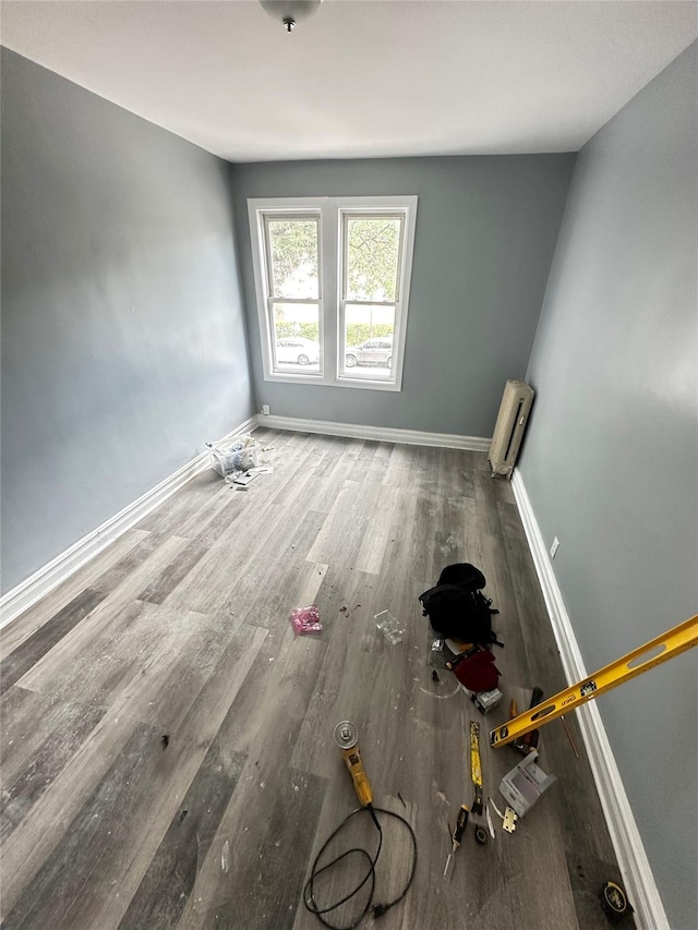 1661 E 172nd St, Bronx, NY 10472 - empty room featuring wood finished floors and radiator