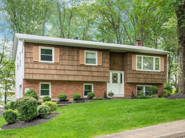 17 Woodrum Dr, Stony Point, NY 10980 - raised ranch featuring a front lawn, a chimney, and brick siding