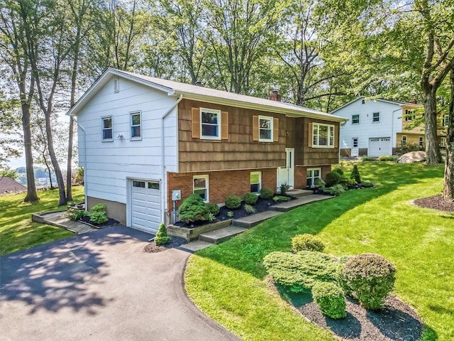 17 Woodrum Dr, Stony Point, NY 10980 - view of front of property featuring driveway, an attached garage, a front lawn, and a chimney