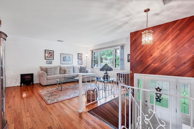 17 Woodrum Dr, Stony Point, NY 10980 - living area featuring wood finished floors, wooden walls, and a chandelier