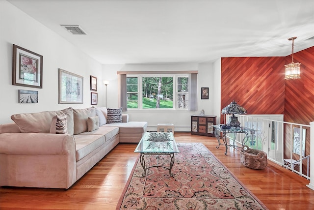 17 Woodrum Dr, Stony Point, NY 10980 - living area featuring a baseboard radiator, wooden walls, and light wood-type flooring