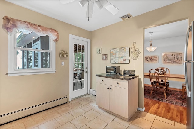17 Woodrum Dr, Stony Point, NY 10980 - kitchen featuring baseboard heating, freestanding refrigerator, dark countertops, and light tile patterned floors