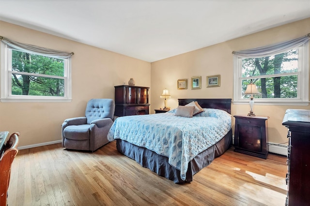 17 Woodrum Dr, Stony Point, NY 10980 - bedroom with hardwood / wood-style flooring, multiple windows, and a baseboard radiator