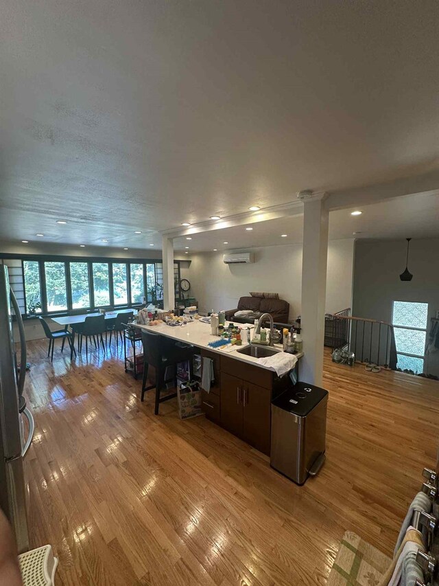 2936 216th St, Bayside, NY 11360 - kitchen with open floor plan, light wood-style flooring, freestanding refrigerator, light countertops, and a wall unit AC