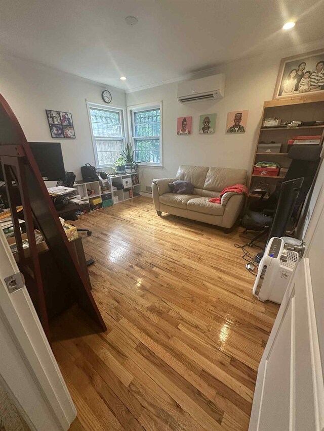 2936 216th St, Bayside, NY 11360 - living area with a wall mounted AC, wood finished floors, a desk, arched walkways, and recessed lighting