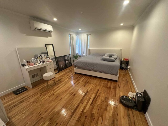 2936 216th St, Bayside, NY 11360 - bedroom featuring crown molding, a wall unit AC, wood finished floors, and recessed lighting