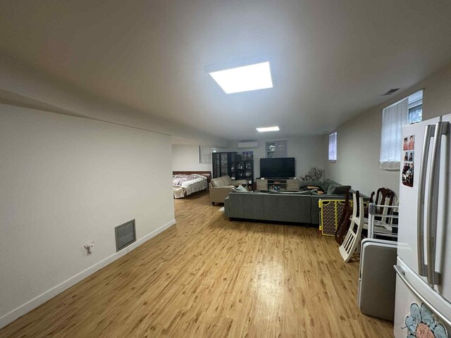 2936 216th St, Bayside, NY 11360 - living room with light wood-type flooring and a wall mounted AC