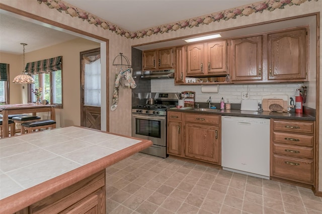 2 Valley View Cir, Warwick, NY 10990 - kitchen featuring white dishwasher, stainless steel range with gas stovetop, under cabinet range hood, backsplash, and tile counters