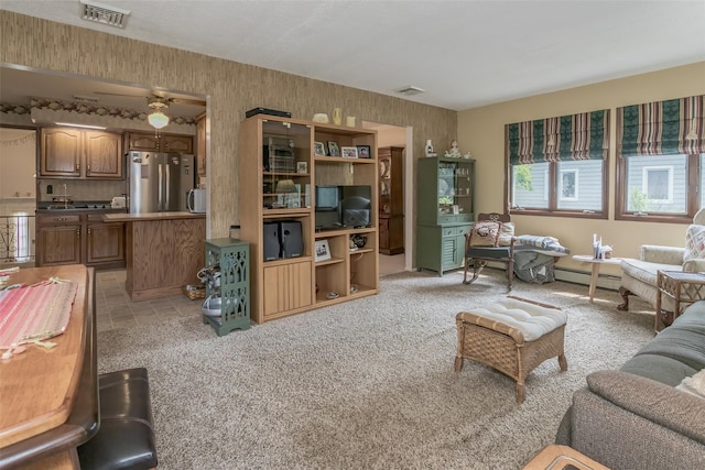 2 Valley View Cir, Warwick, NY 10990 - living area with wallpapered walls, a baseboard heating unit, ceiling fan, and light carpet