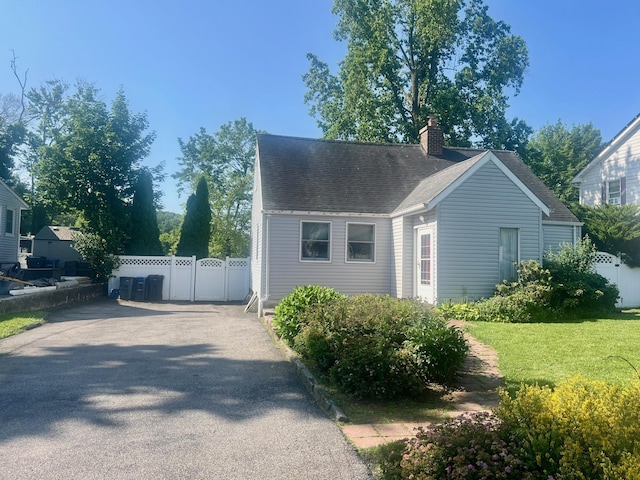 32 Beaver Hill Rd, Elmsford, NY 10523 - view of side of home featuring a chimney and asphalt driveway