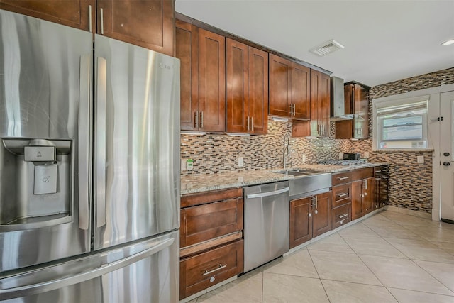 2 Janet Ln, Commack, NY 11725 - kitchen featuring appliances with stainless steel finishes, wall chimney exhaust hood, backsplash, light tile patterned floors, and light stone countertops