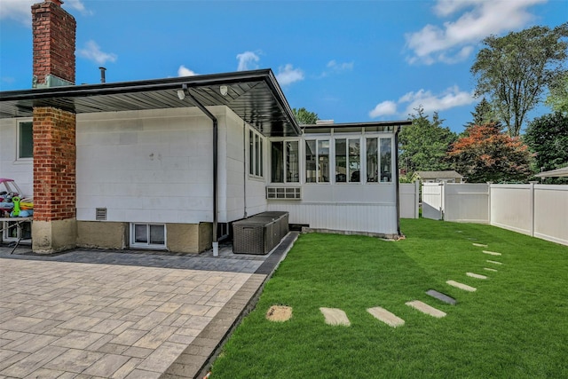 2 Janet Ln, Commack, NY 11725 - rear view of house with a sunroom, a patio area, and a chimney