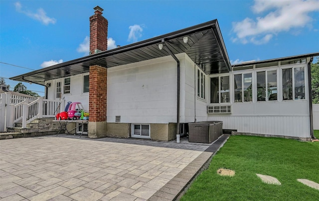 2 Janet Ln, Commack, NY 11725 - view of property exterior featuring a chimney, a yard, a patio, and a sunroom
