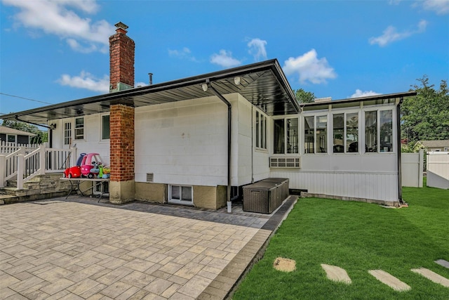 2 Janet Ln, Commack, NY 11725 - back of house featuring a chimney, a patio area, and a sunroom