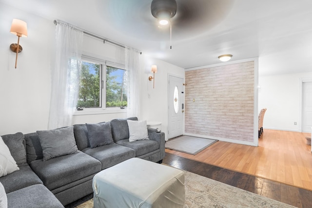 121 Thomas Ave, Bethpage, NY 11714 - living area with a ceiling fan, wood finished floors, and brick wall