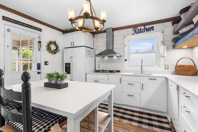 121 Thomas Ave, Bethpage, NY 11714 - kitchen featuring wall chimney exhaust hood, white appliances, a chandelier, backsplash, and white cabinetry