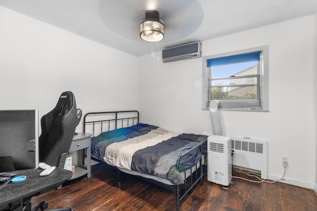 121 Thomas Ave, Bethpage, NY 11714 - bedroom with a wall mounted air conditioner, radiator, wood finished floors, a ceiling fan, and an office area