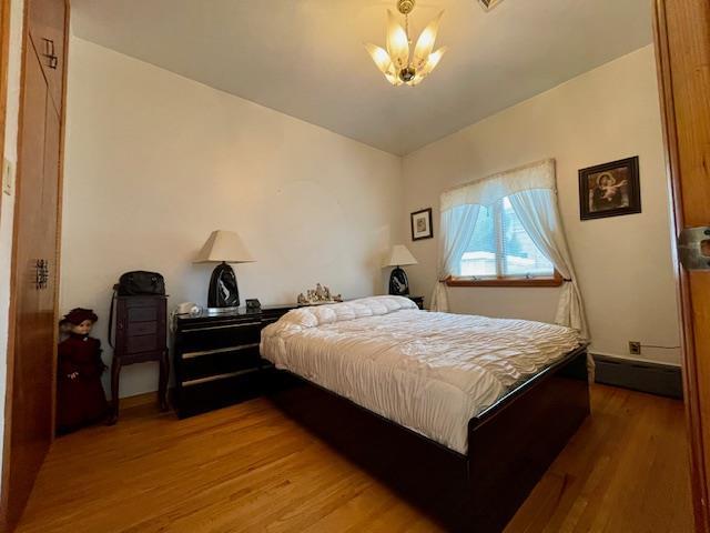 53-80 72nd Pl, Maspeth, NY 11378 - bedroom featuring a chandelier and wood finished floors