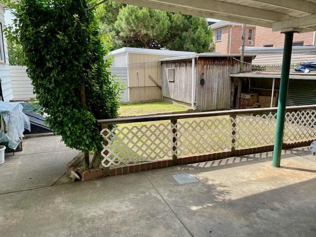53-80 72nd Pl, Maspeth, NY 11378 - view of patio / terrace with a storage unit