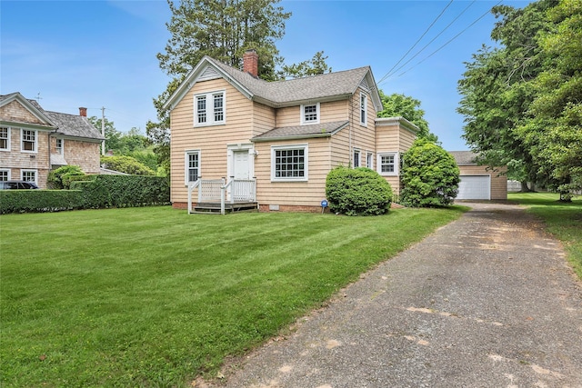 160 Newtown Ln, East Hampton, NY 11937 - traditional-style home featuring a chimney, a front lawn, roof with shingles, a detached garage, and an outdoor structure