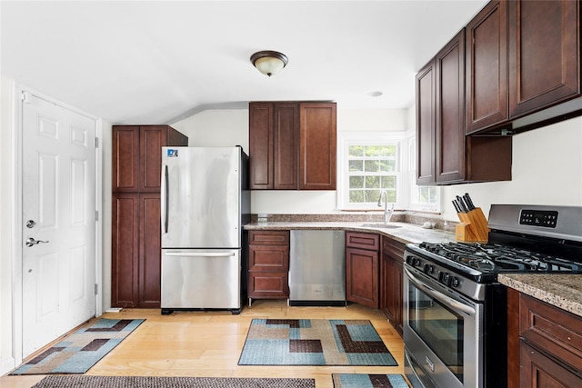 160 Newtown Ln, East Hampton, NY 11937 - kitchen featuring appliances with stainless steel finishes, light wood-style flooring, dark brown cabinetry, and lofted ceiling