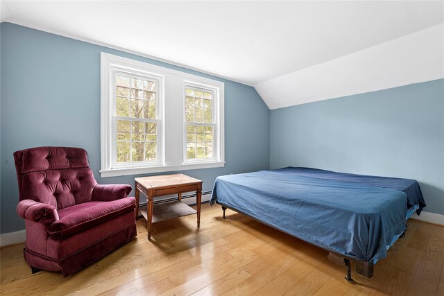 160 Newtown Ln, East Hampton, NY 11937 - bedroom featuring a baseboard radiator, vaulted ceiling, and light wood-style floors