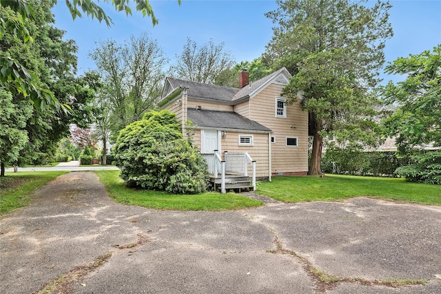 160 Newtown Ln, East Hampton, NY 11937 - view of side of home with a chimney, a yard, and roof with shingles