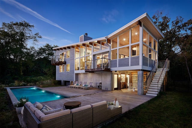 34 Old Neck Rd S, Center Moriches, NY 11934 - rear view of property with a balcony, a chimney, a wooden deck, an outdoor pool, and an outdoor hangout area