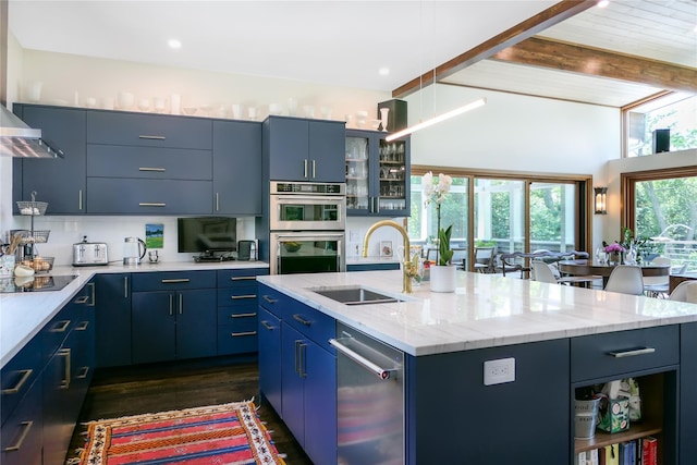 34 Old Neck Rd S, Center Moriches, NY 11934 - kitchen featuring appliances with stainless steel finishes, blue cabinets, a center island with sink, beam ceiling, and dark wood-style flooring