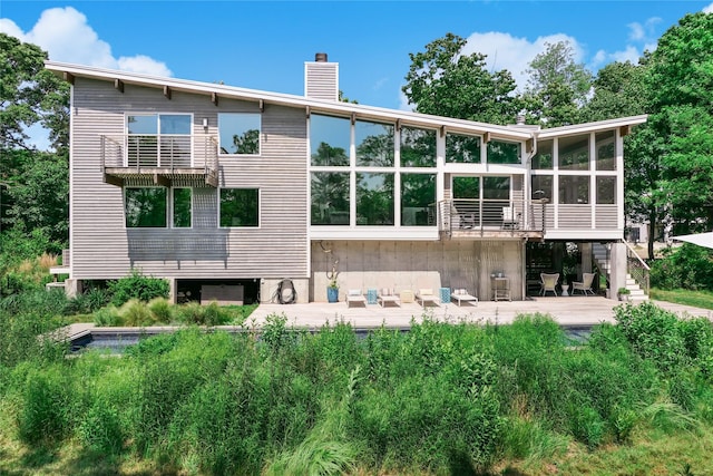 34 Old Neck Rd S, Center Moriches, NY 11934 - rear view of house with a sunroom, a patio, a chimney, stairway, and outdoor lounge area