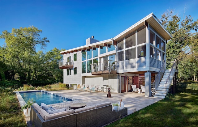 34 Old Neck Rd S, Center Moriches, NY 11934 - back of house with an outdoor hangout area, a patio, a sunroom, an outdoor pool, and a chimney