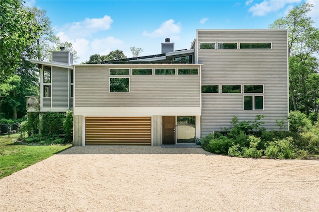 34 Old Neck Rd S, Center Moriches, NY 11934 - modern home with a chimney, driveway, and a garage