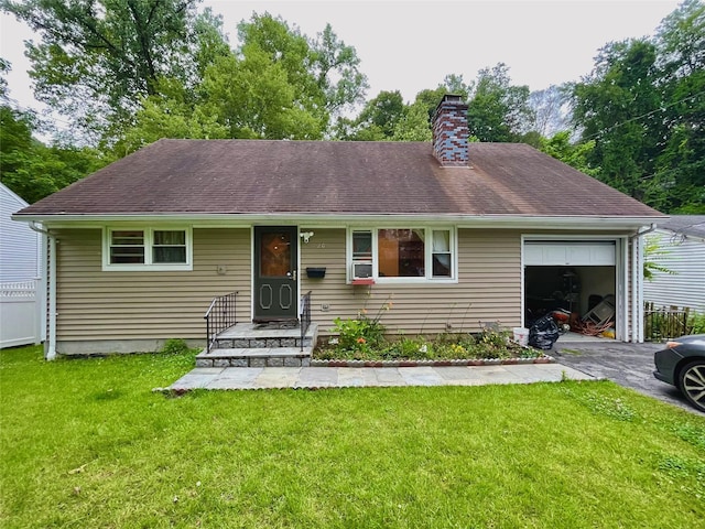 20 Pine Ave, Ossining, NY 10562 - view of front of property with a garage, asphalt driveway, a chimney, and a front lawn
