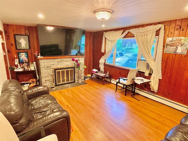 20 Pine Ave, Ossining, NY 10562 - living area featuring wood walls, wood finished floors, a brick fireplace, cooling unit, and a baseboard radiator