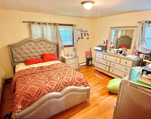 20 Pine Ave, Ossining, NY 10562 - bedroom featuring wood finished floors and a baseboard heating unit