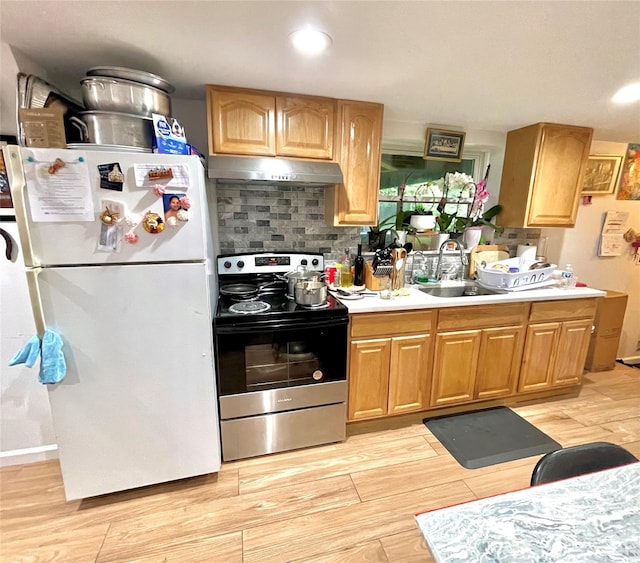 20 Pine Ave, Ossining, NY 10562 - kitchen with freestanding refrigerator, stainless steel electric range oven, under cabinet range hood, light countertops, and recessed lighting