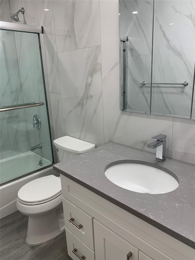 5323 82nd St, Elmhurst, NY 11373 - bathroom with vanity, combined bath / shower with glass door, and wood finished floors