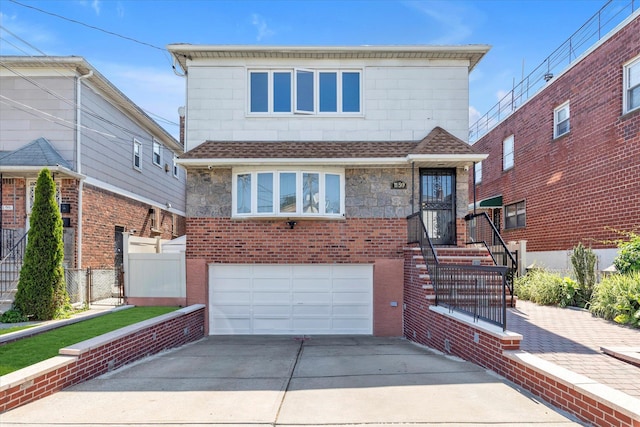 1159 129th St, College Point, NY 11356 - view of front of property featuring concrete driveway, a garage, and a shingled roof
