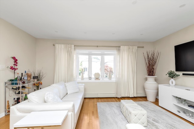 1159 129th St, College Point, NY 11356 - living area featuring light wood finished floors and baseboard heating