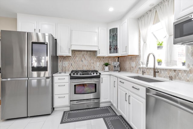 1159 129th St, College Point, NY 11356 - kitchen with stainless steel appliances, light countertops, white cabinetry, and recessed lighting