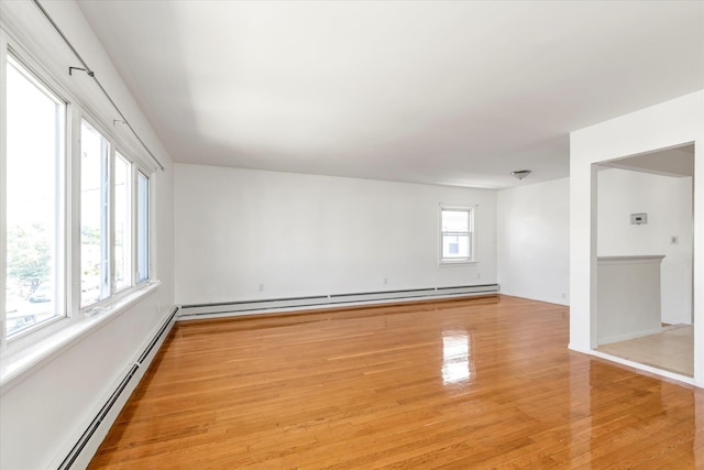1159 129th St, College Point, NY 11356 - unfurnished room with baseboard heating, a baseboard radiator, and light wood-type flooring