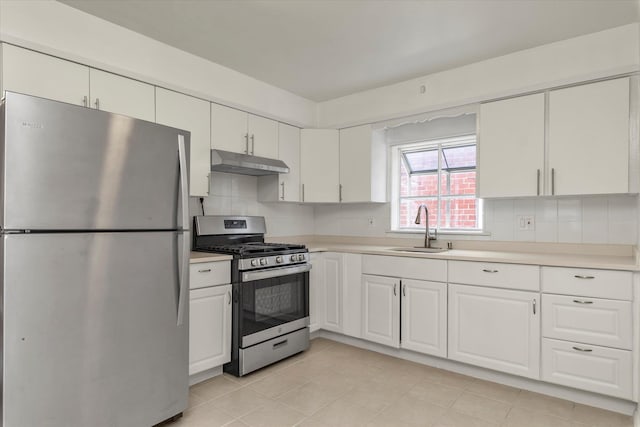 1159 129th St, College Point, NY 11356 - kitchen with appliances with stainless steel finishes, under cabinet range hood, light countertops, white cabinets, and decorative backsplash