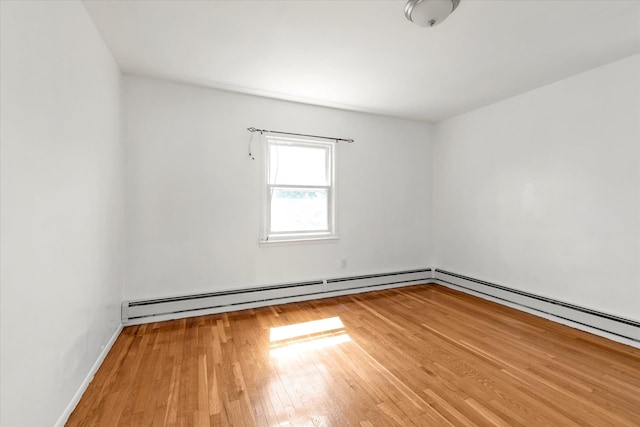 1159 129th St, College Point, NY 11356 - unfurnished room with wood finished floors and a baseboard radiator
