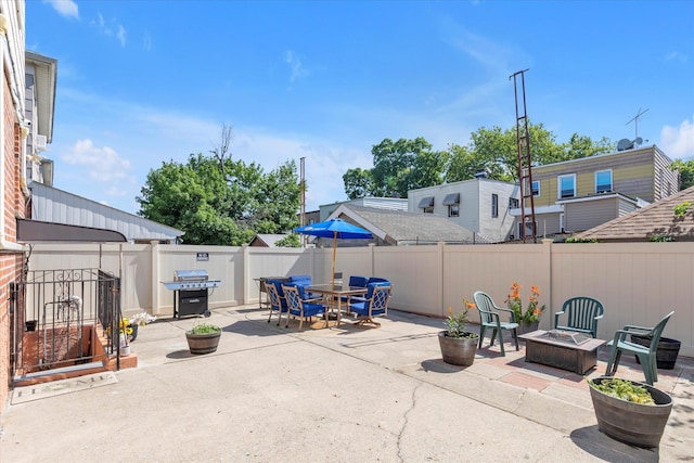 1159 129th St, College Point, NY 11356 - fenced backyard with a patio, a fire pit, and a grill